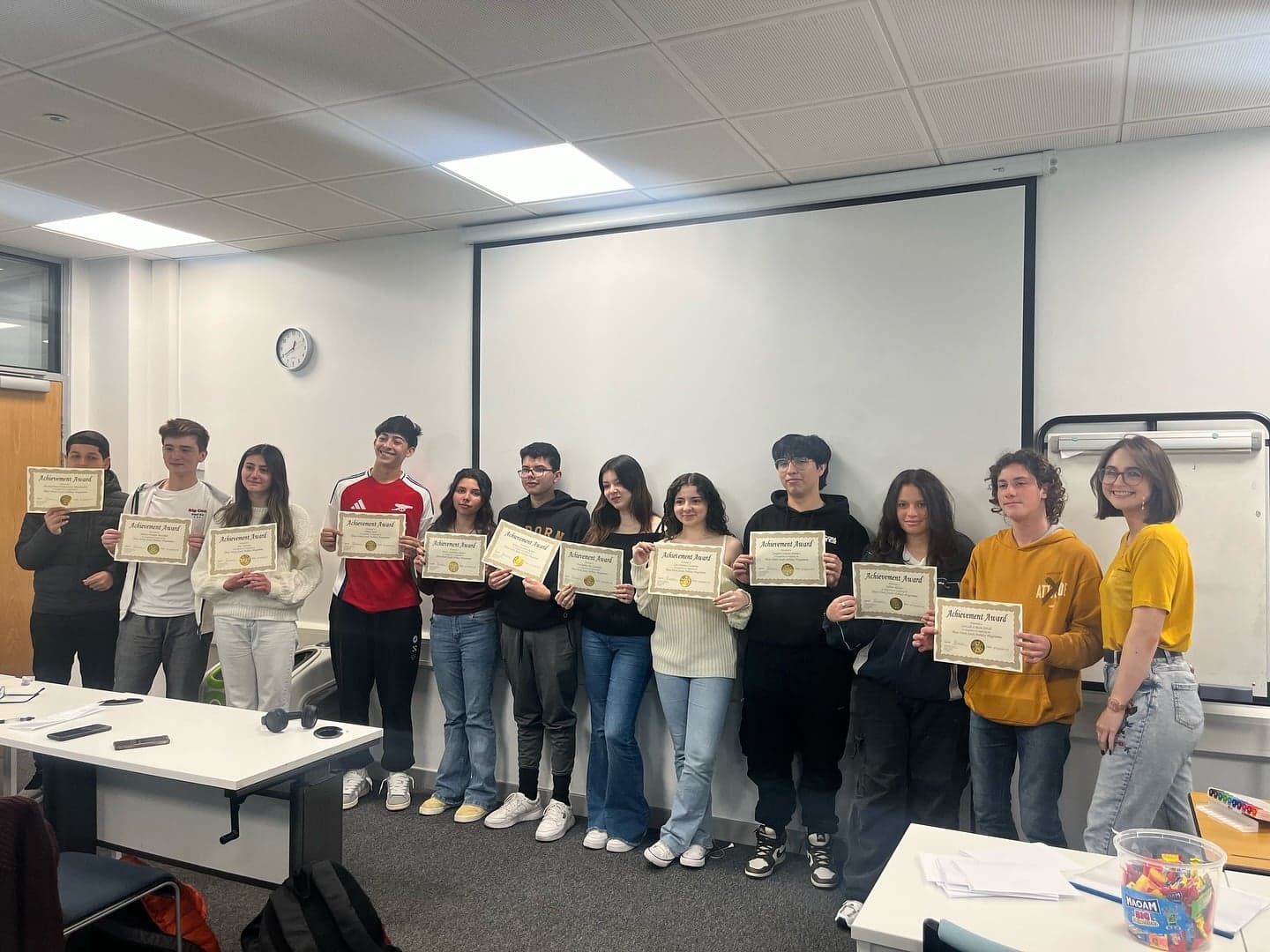 Students holding their certificates at the end of a course