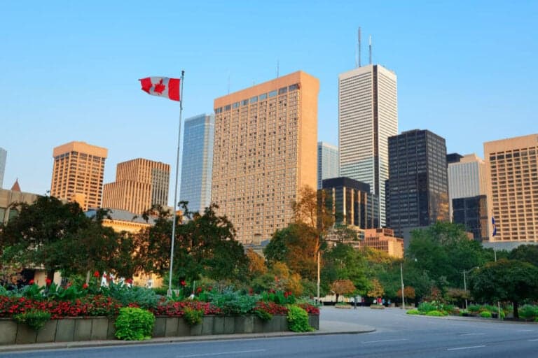 Toronto's downtown skyline, with a Canadian flag in the foreground