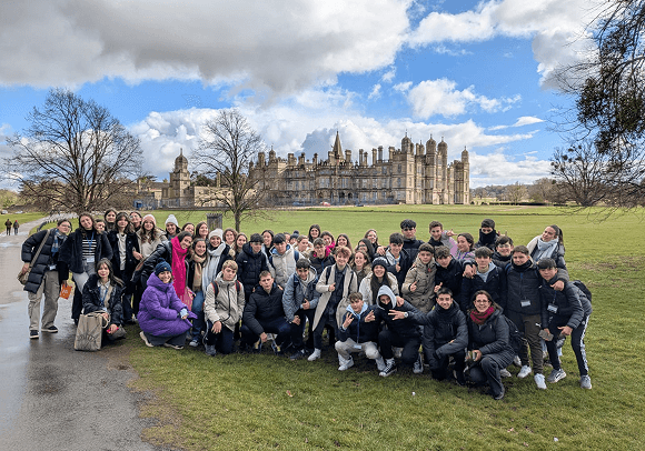 A large Roseworth group on the lawn in front of an Elizabethan country house in England