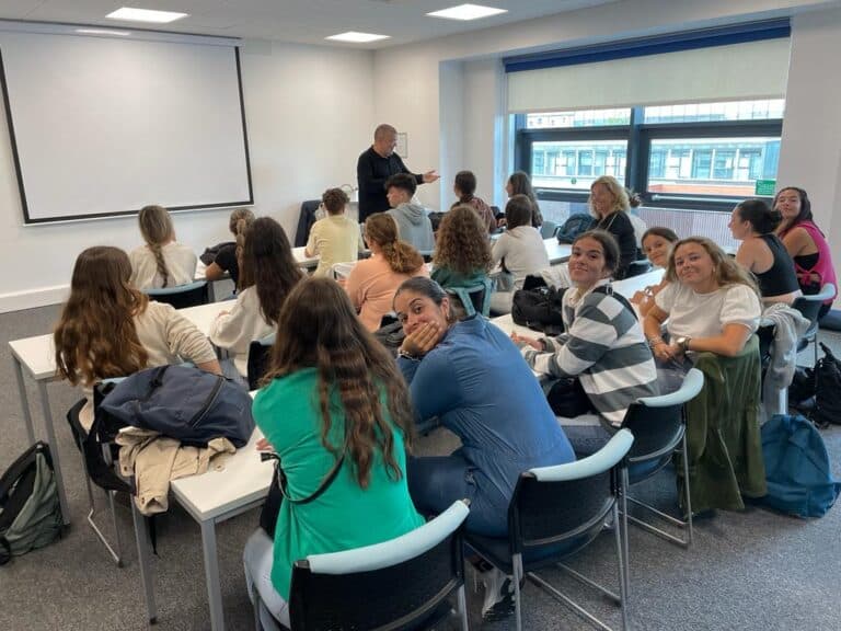 Students talking in a seminar room at the Newcastle campus
