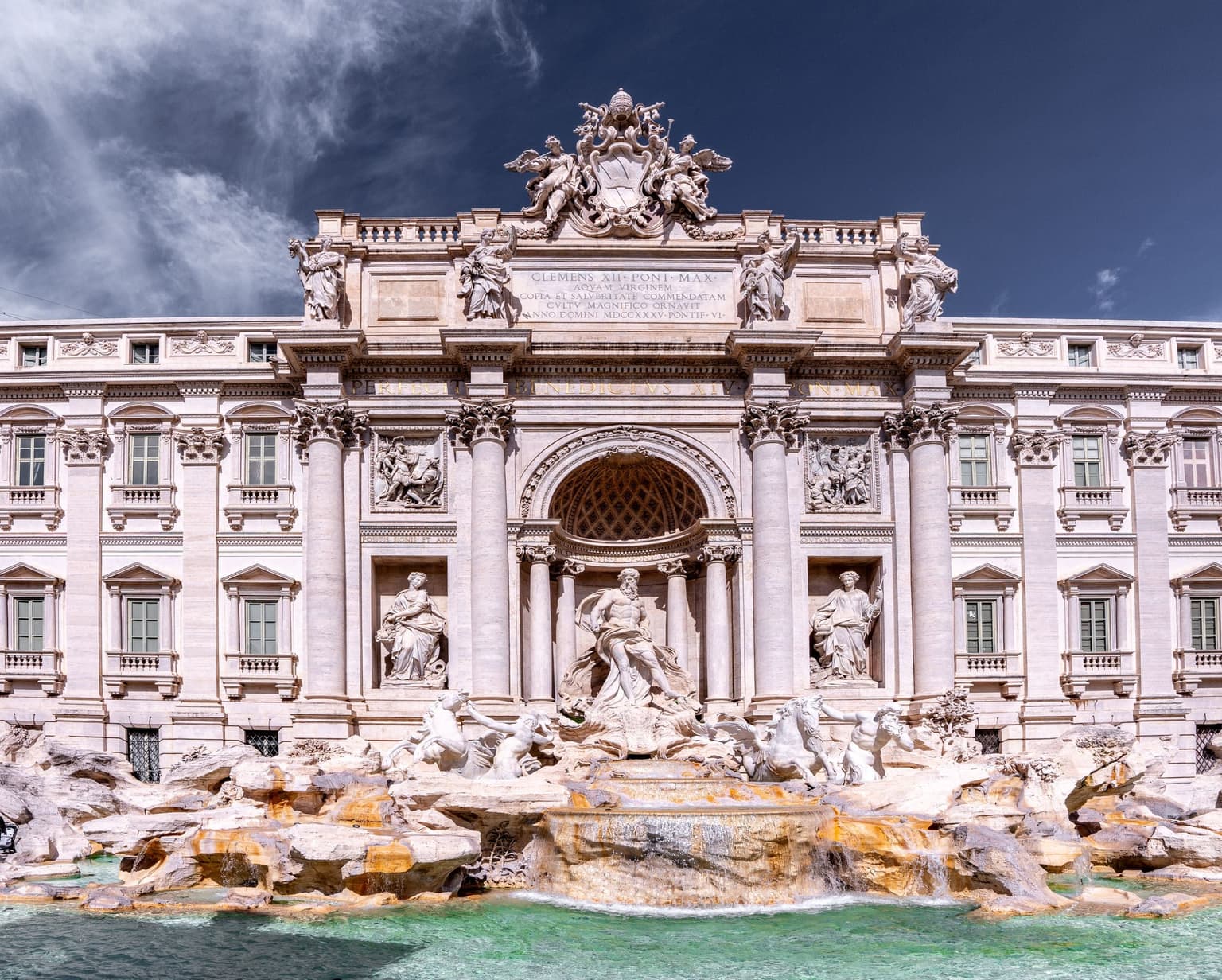 The Trevi Fountain in Rome under a deep blue sky