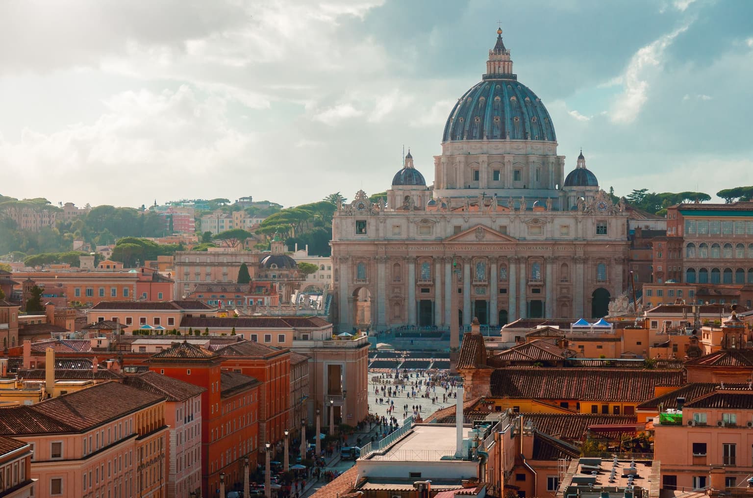 St Peter's Basilica in Vatican City, sunlit above the rooftops of Rome